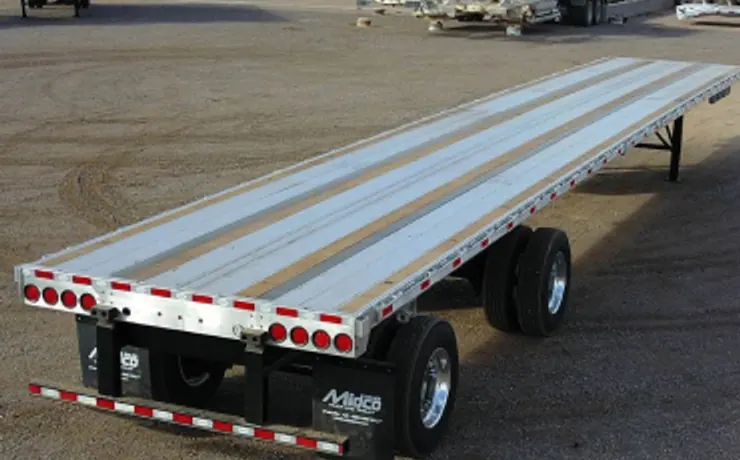 Empty aluminium flatbed trailer