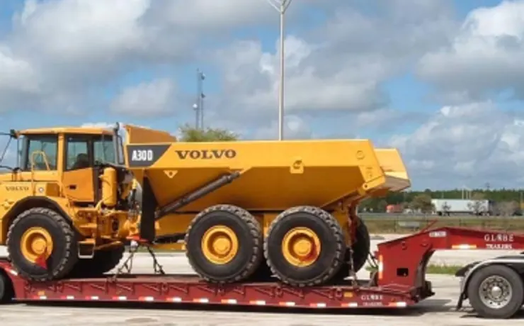 Lowboy RGN trailer loaded with a haul truck