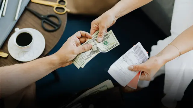 Cash and an invoice changing hands